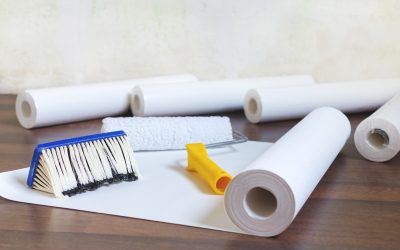 preparation for home repair, wallpaper rolls and brush on the floor